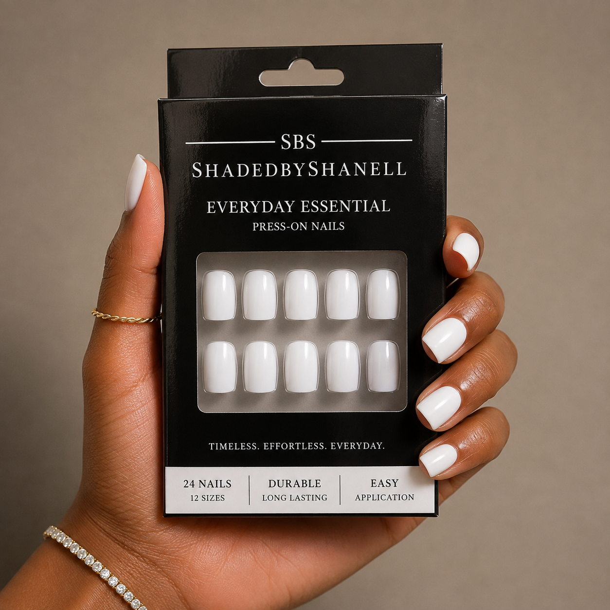 Woman wearing luxury embellished French tip nails with jewel-inspired accents