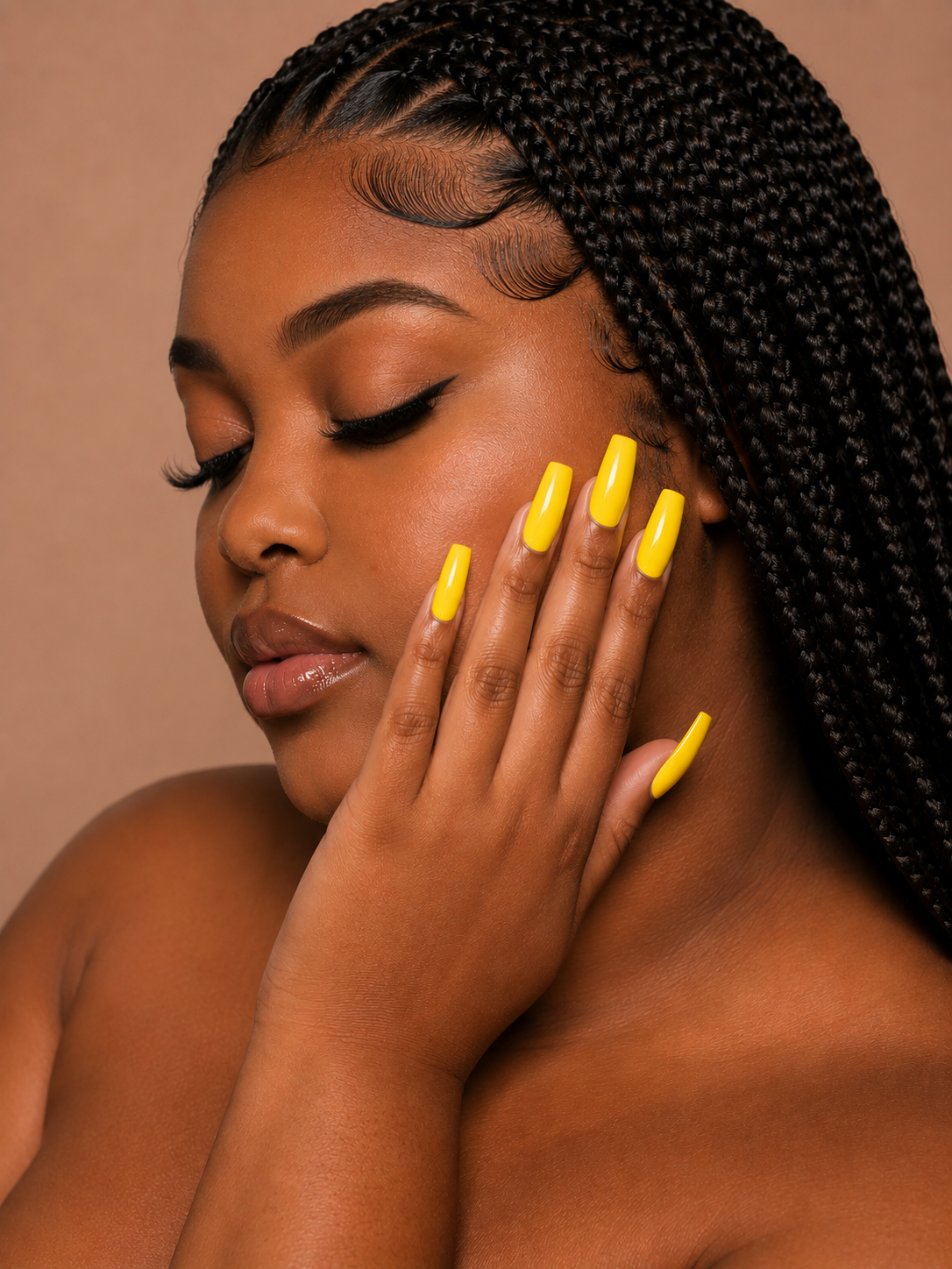 Woman with knotless braids and yellow ShadedbyShanell press-on nails on a beige background