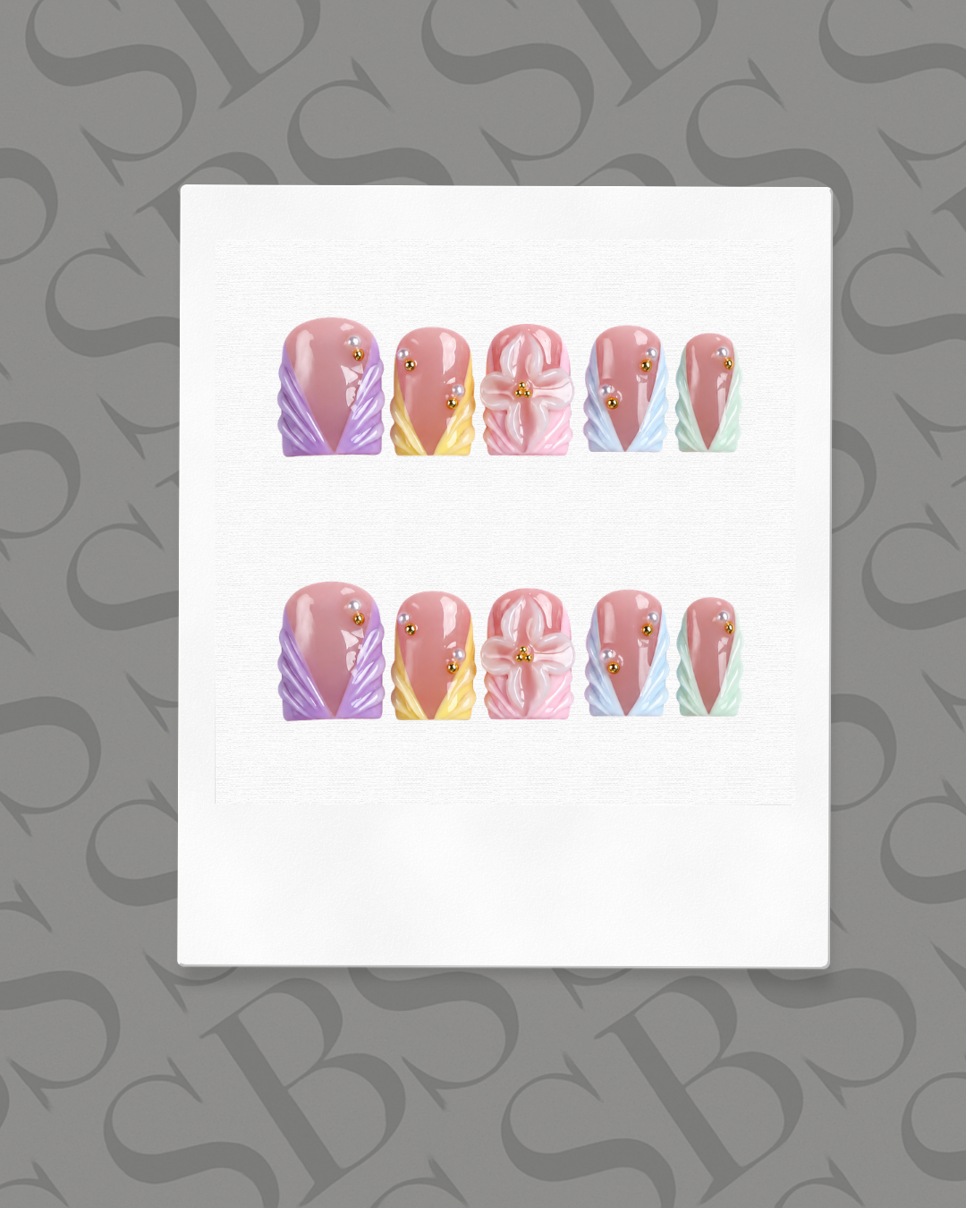 Set of nail art designs on a white card with a gray background