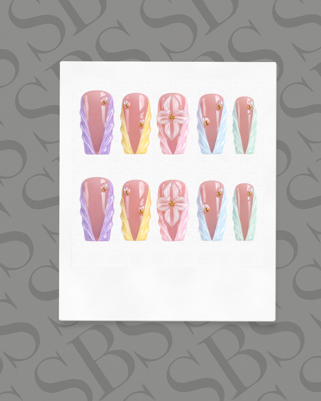 Set of nail art designs on a white card with a gray background