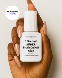 Hand holding a bottle of 3 Second Super Brush-On Nail Glue with a neutral background