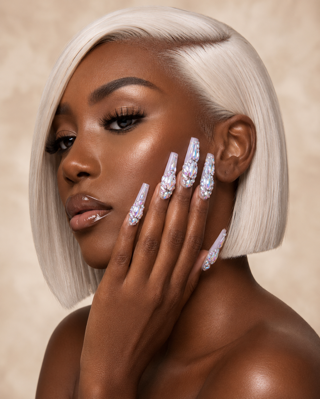 Woman with platinum blonde hair and rhinestone ShadedbyShanell press-on nails against a beige background