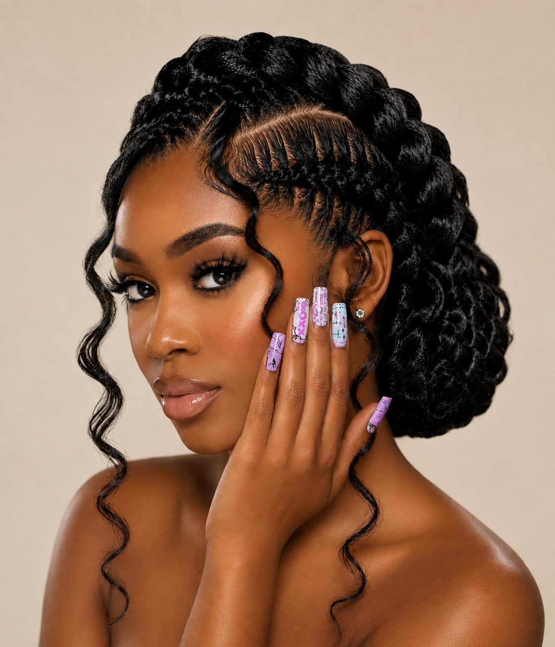 A close-up portrait of a woman with elaborate black braided and curled hair, posing with her hand near her face against a plain beige background.